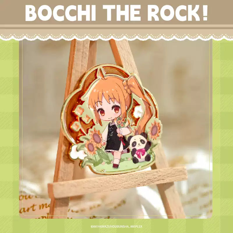 A China Limited metal pin badge of Ichiji Nijika from Bocchi the Rock!, she's in chibi form and wearing oriental cloth, with a panda beside her.