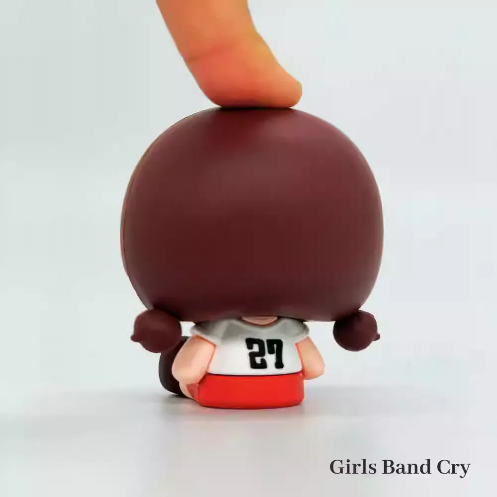 A chibi-style PVC mini figure of Seri from Crying Girls Band, featuring an adorable two-heads-tall design with large, glossy dot eyes and a teary, pouty expression. The figure captures her signature outfit—likely her school uniform or band costume—in soft, pastel colors, with exaggerated tiny hands and stubby legs adding to the cuteness. The compact size and smooth PVC material make it perfect for desk displays or collection shelves.