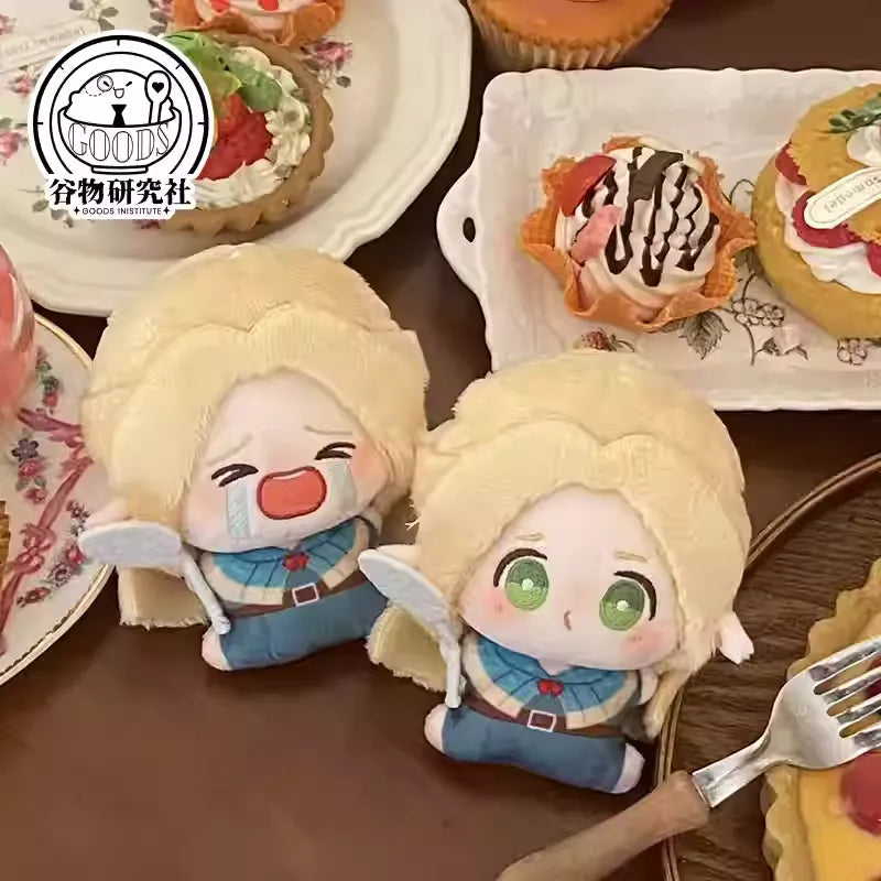 Two mini plush keychains of Marcille from Delicious in Dungeon (Dungeon Meshi). The first has a round, pouty ‘bun face’ with flushed cheeks and big sparkling eyes, while the second shows her crying dramatically with teardrops and a wobbly frown. Both have her signature blonde wavy hair, pointy elf ears, and soft squishy fabric—perfect for fans to collect!