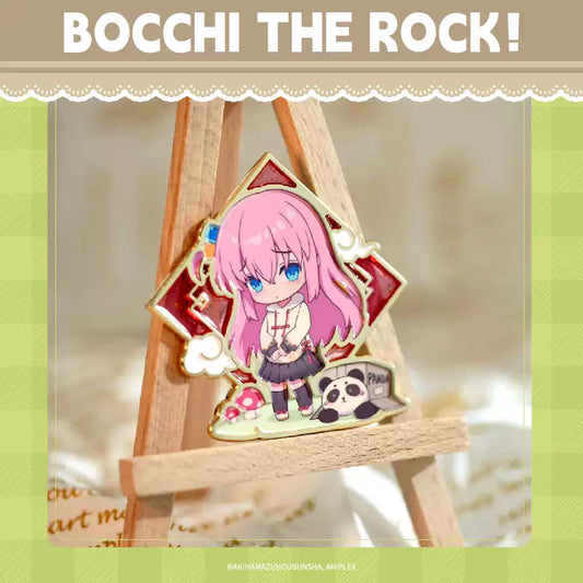 A China Limited metal pin badge of Gotoh Hitori from Bocchi the Rock!, she's in chibi form and wearing oriental cloth, with panda beside her.