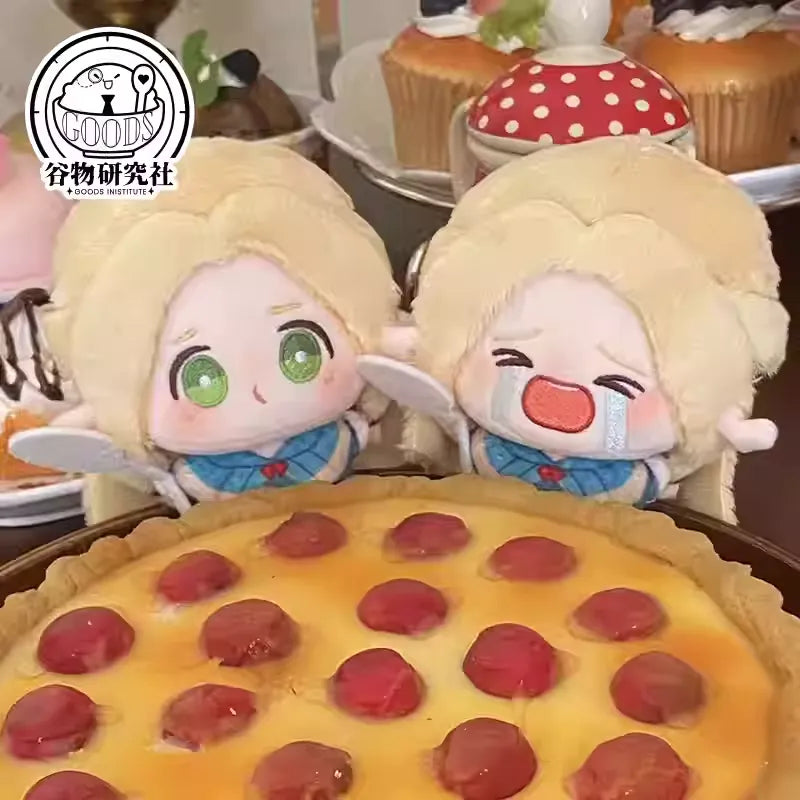 Two adorable mini plush keychains of Marcille from Delicious in Dungeon (Dungeon Meshi) posed in front of a giant, mouthwatering pizza. One keychain shows Marcille with a round, pouty 'bun face' and flushed cheeks, while the other depicts her crying dramatically with teardrops. Both feature her signature blonde hair, pointy elf ears, and soft squishy fabric. The golden cheese and colorful toppings of the pizza make it look irresistibly delicious, creating a fun contrast with Marcille's exaggerated expressio