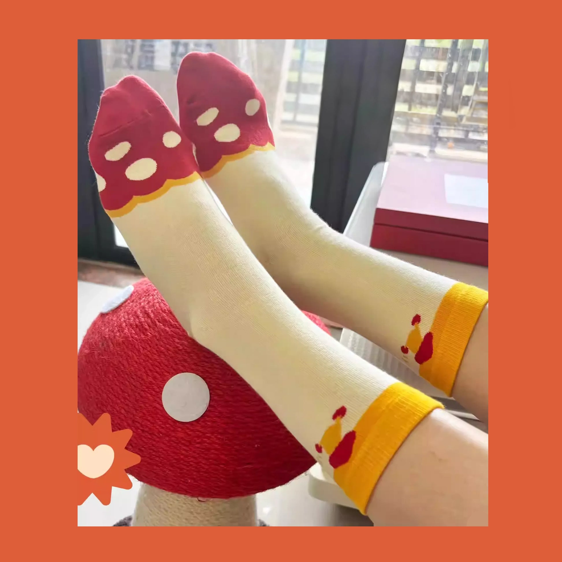A promotional image for Delicious in Dungeon (Dungeon Meshi) fan-made mid-crew socks, featuring the beloved Walking Mushroom design. The socks boast a vibrant red, white, and yellow color scheme, with the mushroom's iconic red cap, white spots, and wiggly yellow legs. The mid-calf length offers both style and comfort, perfect for fans to showcase their love for the series in a playful, wearable way. The product is displayed flat against a clean background, highlighting the charming and detailed 