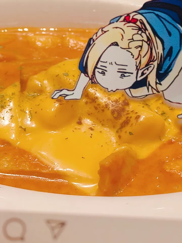 An acrylic transparent card featuring Delicious in Dungeon (Dungeon Meshi)'s Marcille in a comical pose—lying flat on the ground, desperately inhaling the scent of food with starry-eyed obsession. The card is playfully placed next to an aromatic dish (e.g., a sizzling steak or buttery pastry), creating the illusion that Marcille is literally fangirling over the meal. The translucent acrylic blends the artwork with the real food, enhancing the humor of her dramatic antics.
