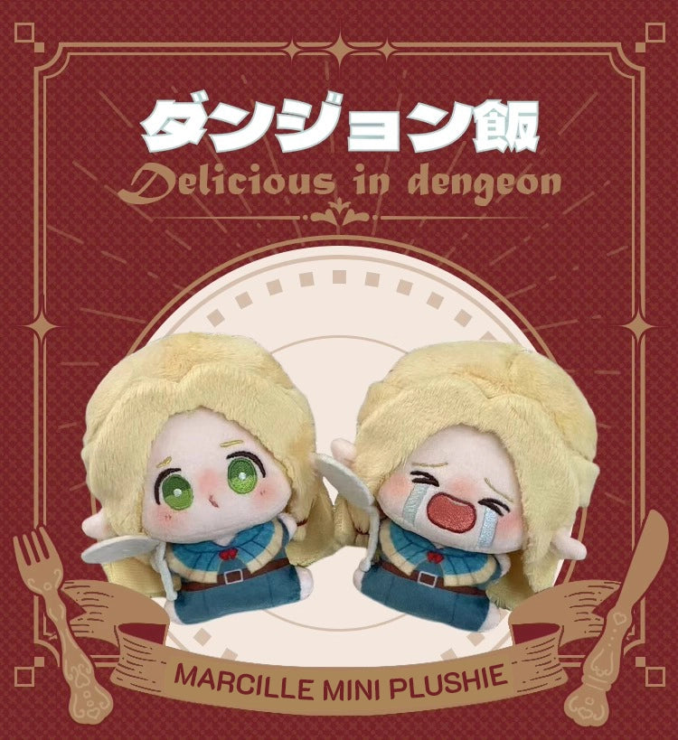 Two mini plush keychains of Marcille from Delicious in Dungeon (Dungeon Meshi). The left has a round, pouty ‘bun face’ with flushed cheeks and big sparkling eyes, while the right shows her crying dramatically with teardrops and a wobbly frown. Both have her signature blonde wavy hair, pointy elf ears, and soft squishy fabric—perfect for fans to collect!
