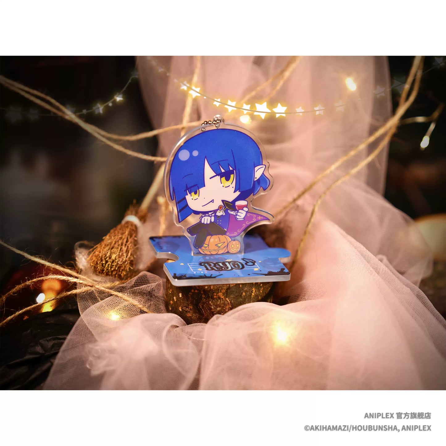 A Halloween theme acrylic mini stand of Bocchi the Rock! character Yamada ryou, she's wearing vampire like cloth, with a pumpkin beside her